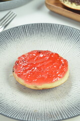 Serabi pancakes topped with strawberry jam, a traditional Indonesian snack