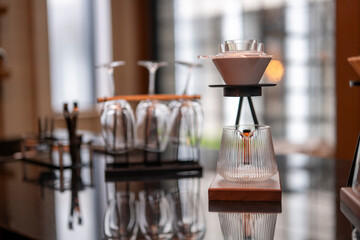 Coffee brewing in a modern cafe using a pour over method with paper filter
