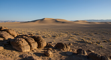 Serene Desert Landscape with Sand Dunes and Rocky Outcrops in Namibia, Africa