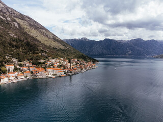 Fototapeta premium Aerial view of Saint George Island near Perast in the Bay of Kotor, Montenegro, surrounded by calm sea and mountains. g.