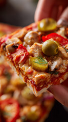 square pizza slice macro shot red signature sauce, chicken, pork tenderloin, mushrooms, sausages, pickled cucumbers, tomato, olives, cheese, dill. appetizing slice side view in hands