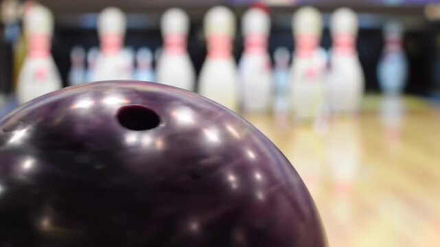 Bowling ball in front of bowling pins