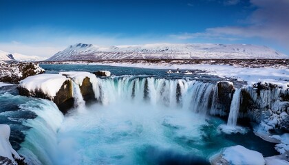 godafoss waterfall cascading through snowy landscape in iceland