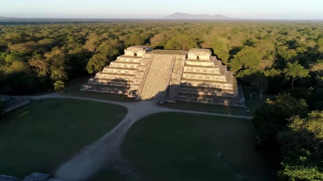 Aerial view of kohunlich mayan pyramid amidst lush greenery in yucatn, mexico, showcasing ancient architecture and rich cultural heritage of the region