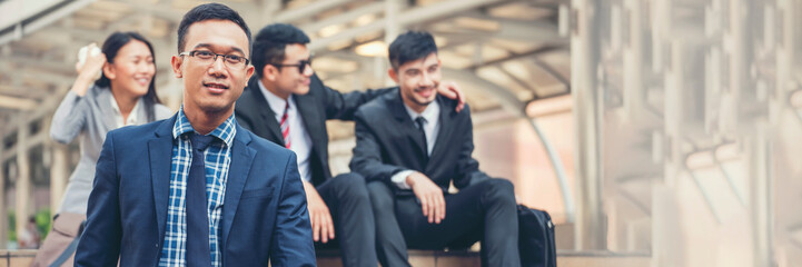 Banner Portrait Group of businesspeople arms crossed smiling look at camera in modern city background. Banner Happy teams partnership. Business people teams positive teamwork standing with copy space