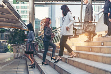 Crowd business people walking go to work in modern city life to working office. Crowd worker group of people busy life with businesswoman,  man in urban street city lifestyle. Business People Concept