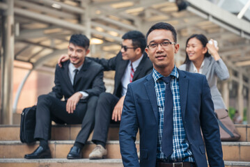 Banner Portrait Group of businesspeople arms crossed smiling look at camera in modern city background. Banner Happy teams partnership. Business people teams positive teamwork standing with copy space