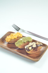 Pukis cake with various toppings of chocolate, cheese, peanuts, and matcha, a traditional Indonesian snack