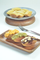Pukis cake with various toppings of chocolate, cheese, peanuts, and matcha, a traditional Indonesian snack