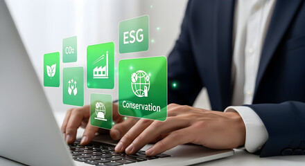 Fototapeta premium Executive types on laptop with ESG icons overlay. Background office setting. Concept sustainability