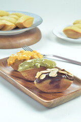 Pukis cake with various toppings of chocolate, cheese, peanuts, and matcha, a traditional Indonesian snack