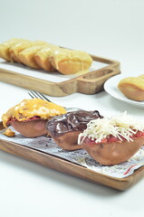 Pukis cake with various toppings of chocolate, cheese, peanuts, and matcha, a traditional Indonesian snack