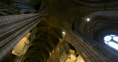Majestic organ pipes reach towards the vaulted ceiling of Liverpool Anglican Cathedral, creating a sense of awe and reverence