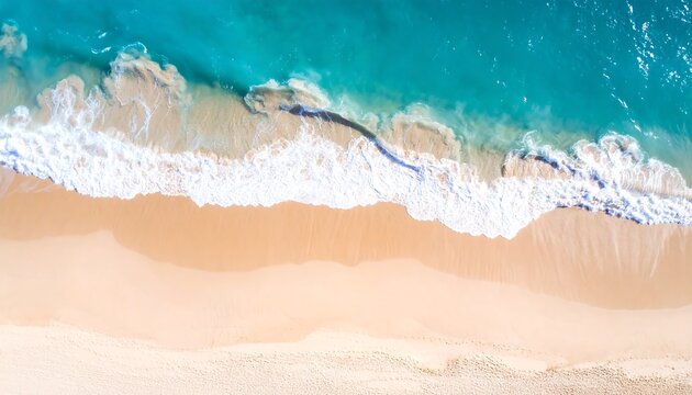 Aerial view of ocean waves gently lapping a pristine sandy beach