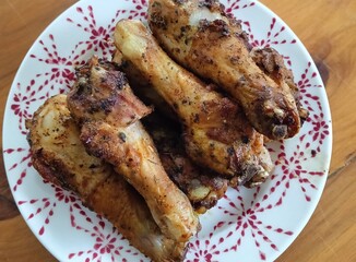 grilled chicken legs on a plate.