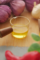 Cooking ingredients on a wooden board with oil and garlic