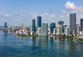 Fototapeta premium Aerial view of Brickell skyscrapers. Modern cityscape of downtown Miami. Panoramic Miami skyline above the coastline. Brickell Key aerial view in Miami.