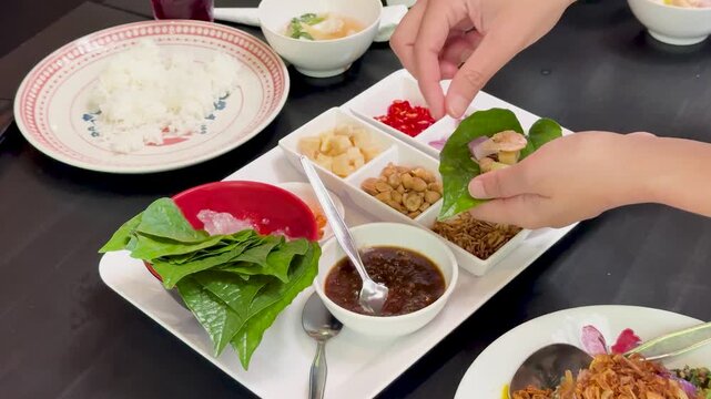 Assembling Miang Kham Savory Leaf Wraps at Dining Table