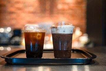 Iced Americano and iced mocha in plastic glass on tray at cafe shop
