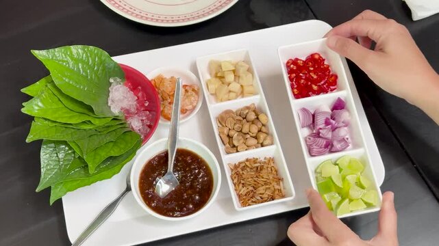 Arranging Miang Kham Ingredients on Serving Tray Overhead