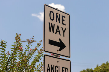 One Way Street Sign Against Blue Sky on a Sunny Day