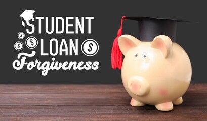 Piggy bank in graduation hat on table. Student loan forgiveness