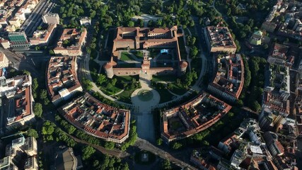Drone footage of Sforza Castle in Milan, Italy. The clip offers a panoramic aerial view of the inner courtyard and medieval structure, showcasing the historical - Powered by Adobe