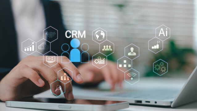 Businessman using CRM system with AI-powered tools for customer relationship management, sales analytics, and digital marketing strategy in a modern office environment.