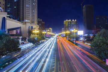 Fototapeta premium Vibrant Urban Night Traffic Scene With Illuminated Street Lights