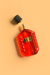 Bottle of luxury perfume on orange background