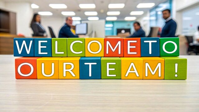 Welcome to our team message in colorful blocks with office team in background
