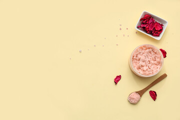 Jar with natural body scrub and dried flowers petals on color background