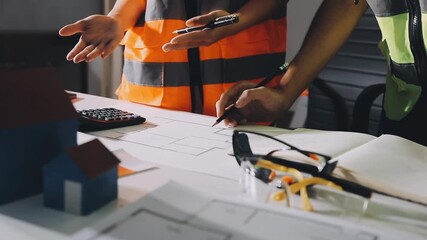 Closeup of team of industrial engineers meeting analyze machinery blueprints consult project on table in manufacturing factory. Working in manufacturing plant or production plant. - Powered by Adobe