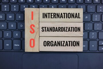 ISO Concept on Wooden Blocks Above Keyboard Highlighting the Theme of International Standardization