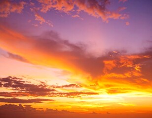 Fototapeta premium Vibrant sunset hues paint the sky with fiery oranges and purples, clouds scattered across the canvas