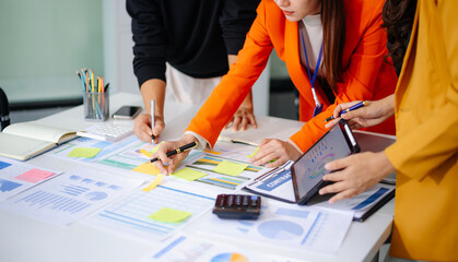 Business People Talking Discussing with financial document data charts and graphs Team business meeting with smart phone and laptop and digital tablet computer