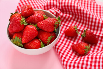 Bowl with sweet fresh strawberries on pink background