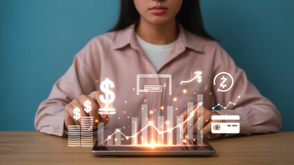 Financial growth: Woman using tablet with financial graphics overlay and investments.