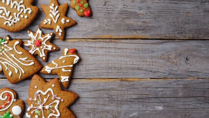 Festive gingerbread cookies with icing on a rustic wooden surface create a cozy Christmas atmosphere.