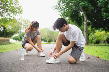 Young Individuals Preparing for Outdoor Exercise, Tying Shoelaces, Healthy Lifestyle, Activity, Physical Fitness, Natural Setting, Morning Routine, Friendship