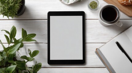 Tablet mockup on white desk with coffee and plants flat lay overhead