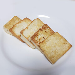 Golden Pan-Fried Tofu (Dubu Buchim) on a White Plate