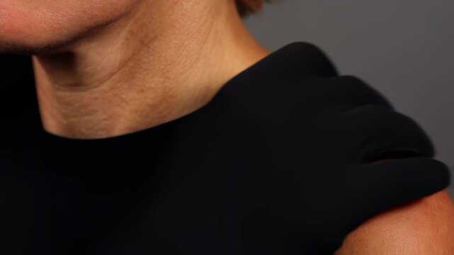 Detailed view of reddened skin with cluster of tiny raised pink dots on shoulder area demonstrating common symptom of photosensitive dermatitis.