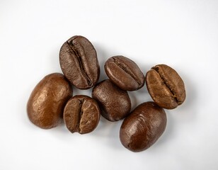 Naklejka premium Aromatic Roasted Coffee Beans Close Up Studio Shot High quality image of several coffee beans on a white background