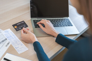 Internet banking, Online shopping at home, asian young woman hand in typing on keyboard, holding credit card, using laptop computer, spending money with purchase on store at home. Shopaholic ecommerce