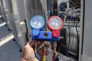 Technician checking the operation of the air conditioner
