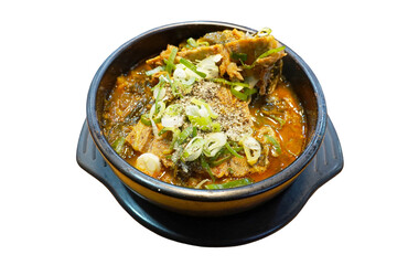 Hearty spicy Korean pork bone soup with vegetables and green onions served in traditional black stone pot perfect comfort food