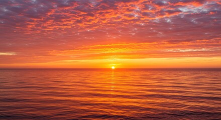 Obraz premium Fiery Sunset Over Calm Ocean Waters with Vibrant Clouds and Golden Light