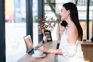 asian freelance people Beautiful business female talking making using casual working with laptop computer for browsing internet, chatting and blogging and smartphone,notebook in coffee shop.