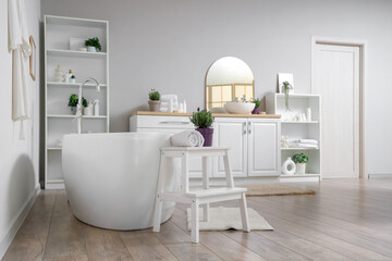 Interior of modern white bathroom with pots of lavender flowers